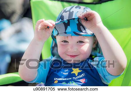 Stock Photography - Boy wearing a sun hat and uv clothing. Fotosearch