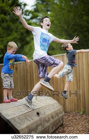 Stock Photography - Boys playing in park. Fotosearch