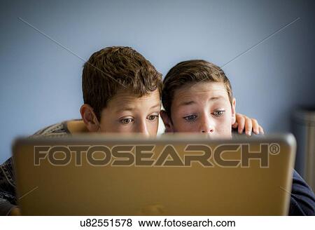 Stock Photo - Boys using laptop. Fotosearch