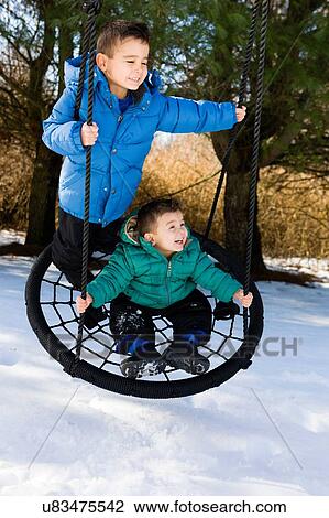 Brothers together on hammock swing looking away smiling View Large Photo Image Stock Image - Brothers together on hammock swing looking away smiling. Fotosearch