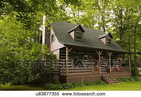 Stock Photography - Brown with green trim Canadian cottage style log home. Fotosearch