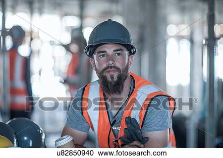 Builder taking a coffee break on construction site View Large Photo Image Stock Image - Builder taking a coffee break on construction site. Fotosearch