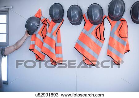 Builders hand removing hard hat from portable cabin wall View Large Photo Image Stock Image - Builders hand removing hard hat from portable cabin wall. Fotosearch