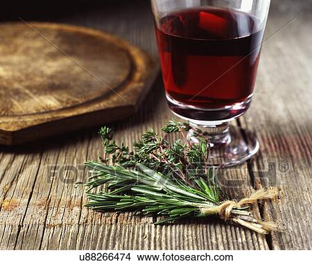Picture - Bunch of rosemary and thyme tied with string, red wine. Fotosearch