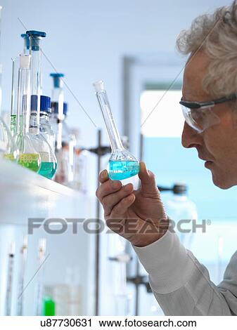 Stock Image - Chemist preparing chemical formula for testing in laboratory. Fotosearch