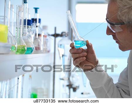 Chemist preparing chemical formula for testing in laboratory View Large Photo Image Stock Photography - Chemist preparing chemical formula for testing in laboratory. Fotosearch