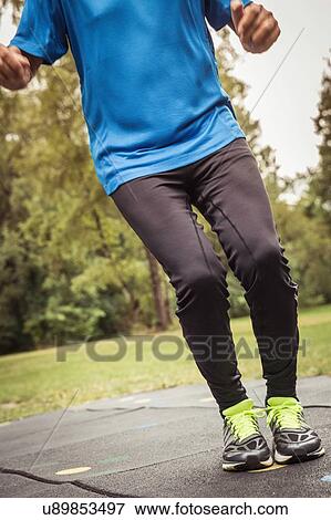 Chest down of senior man wearing sportswear bending knees View Large Photo Image Stock Photo - Chest down of senior man wearing sportswear bending knees. Fotosearch