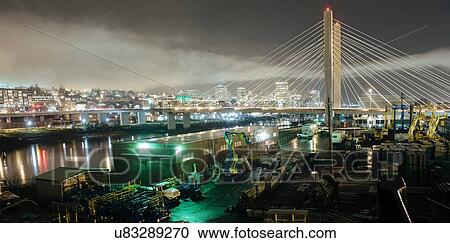Stock Image - "Cityscape of Tacoma Narrows bridge and the Narrows at night, Tacoma, Washington, USA". Fotosearch
