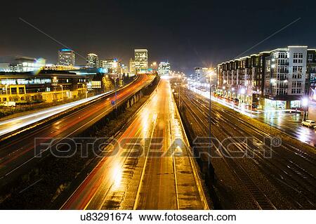 Picture - "Cityscape with flyover next to rail track at night, Tacoma, Washington, USA". Fotosearch