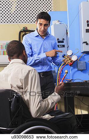 Stock Image - Classroom with one student in wheelchair. Fotosearch