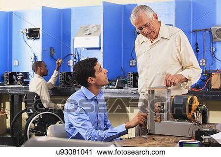 Stock Image - Classroom with student in wheelchair. Fotosearch