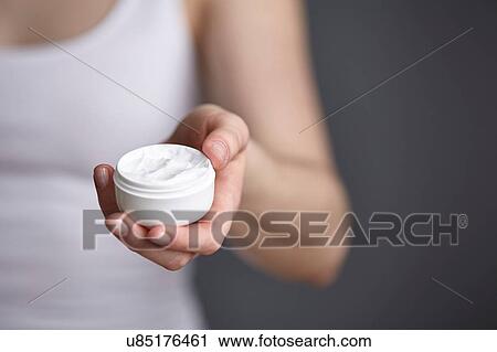 Close up cropped shot of young woman holding moisturiser jar View Large Photo Image Stock Image - Close up cropped shot of young woman holding moisturiser jar. Fotosearch