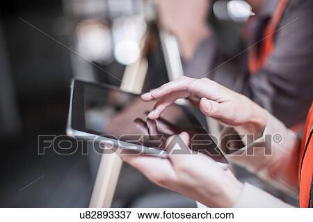 Close up of female surveyor using tablet touchscreen on construction site View Large Photo Image Stock Photo - Close up of female surveyor using tablet touchscreen on construction site. Fotosearch