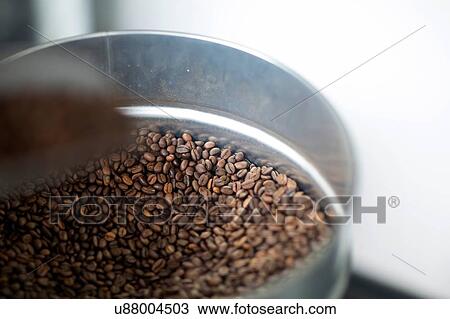 Stock Image - Close up of fresh coffee beans in tin. Fotosearch
