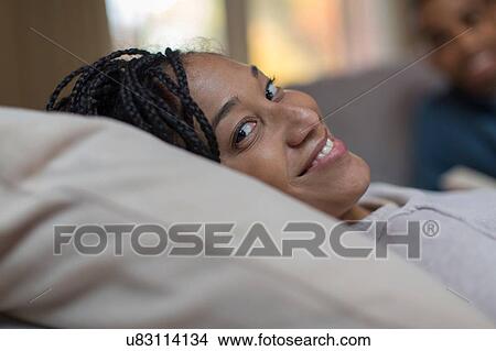 Close up portrait of mid adult woman reclining on living room sofa View Large Photo Image Picture - Close up portrait of mid adult woman reclining on living room sofa. Fotosearch