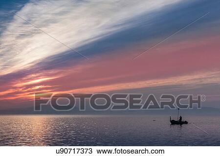 Stock Image - Cloudscape over Lake Maggiore, Piedmont, Lombardy, Italy. Fotosearch