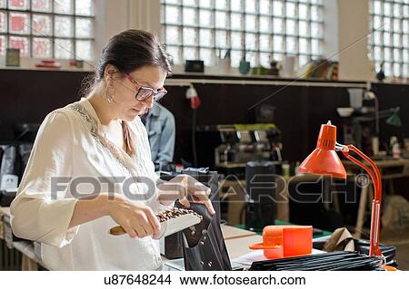 Coffee seller filling bag with coffee beans View Large Photo Image Picture - Coffee seller filling bag with coffee beans. Fotosearch