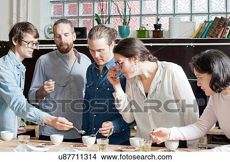Picture - Coffee tasters sipping coffee with spoon. Fotosearch