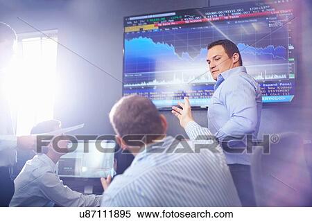 Colleagues in office pointing at wall mounted graphical screen having discussion View Large Photo Image Stock Photography - Colleagues in office pointing at wall mounted graphical screen having discussion. Fotosearch
