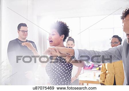 Colleagues in team building task, holding hands covering eyes View Large Photo Image Stock Photo - Colleagues in team building task, holding hands covering eyes. Fotosearch