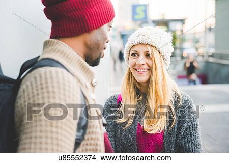 Couple chatting in city View Large Photo Image Picture - Couple chatting in city. Fotosearch