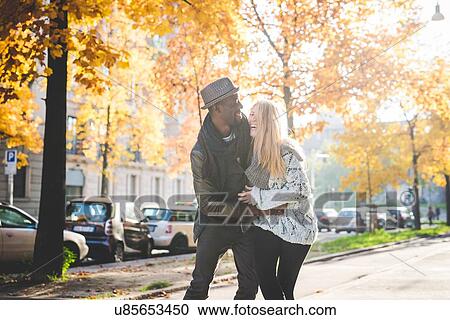 Couple playing on pavement View Large Photo Image Stock Image - Couple playing on pavement. Fotosearch