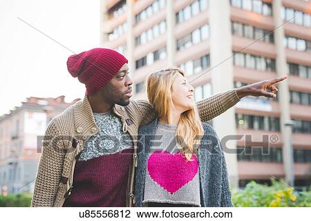 Stock Image - Couple sightseeing in city. Fotosearch