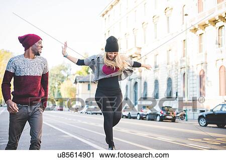 Couple skipping on street View Large Photo Image Stock Image - Couple skipping on street. Fotosearch