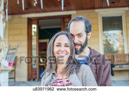 Couple smiling in front of house View Large Photo Image Stock Image - Couple smiling in front of house. Fotosearch