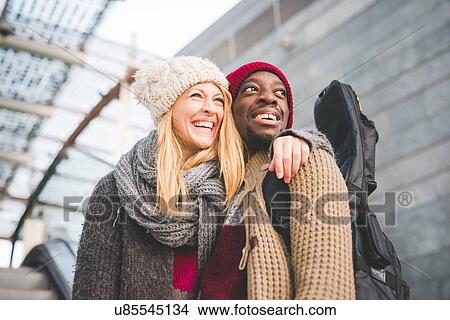 Picture - Couple smiling, leaving mall. Fotosearch