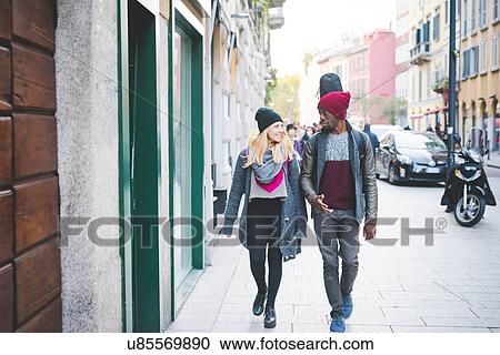 Couple walking on pavement View Large Photo Image Stock Image - Couple walking on pavement. Fotosearch