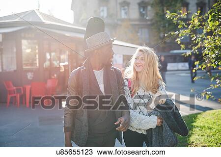Couple walking on pavement View Large Photo Image Stock Image - Couple walking on pavement. Fotosearch