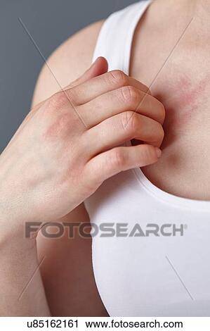 Cropped close up shot of young woman scratching her chest with fingers View Large Photo Image Stock Image - Cropped close up shot of young woman scratching her chest with fingers. Fotosearch