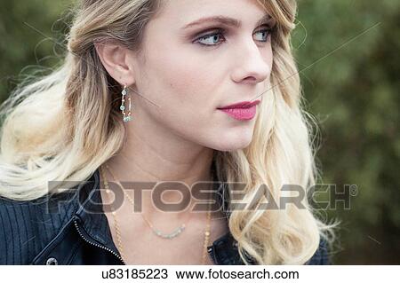 Cropped portrait of young blonde haired woman wearing leather jacket looking down View Large Photo Image Stock Image - Cropped portrait of young blonde haired woman wearing leather jacket looking down. Fotosearch