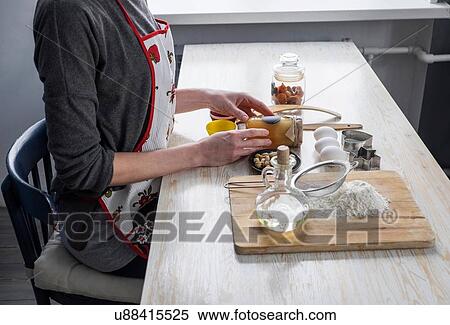 Stock Photography - Cropped shot of woman preparing raw ingredients for baking at kitchen counter. Fotosearch