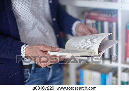 Cropped shot of woman reading book from bookshelves View Large Photo Image Stock Photo - Cropped shot of woman reading book from bookshelves. Fotosearch