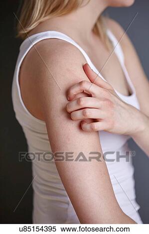Cropped shot of young woman scratching her arm with fingers View Large Photo Image Stock Photography - Cropped shot of young woman scratching her arm with fingers. Fotosearch