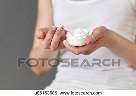 Cropped shot of young woman with moisturiser on fingertips View Large Photo Image Stock Photography - Cropped shot of young woman with moisturiser on fingertips. Fotosearch