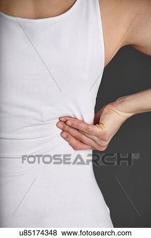Cropped shot of young womans hand massaging her own back View Large Photo Image Stock Photo - Cropped shot of young womans hand massaging her own back. Fotosearch
