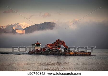 Digger on boat, Lake Maggiore, Piedmont, Lombardy, Italy View Large Photo Image Stock Image - Digger on boat, Lake Maggiore, Piedmont, Lombardy, Italy. Fotosearch