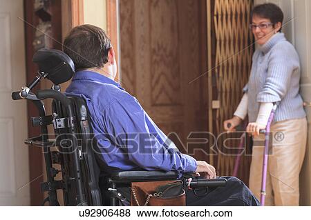 Disabled couple entering a home elevator View Large Photo Image Stock Photo - Disabled couple entering a home elevator. Fotosearch