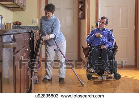 Stock Image - Disabled couple in the kitchen. Fotosearch