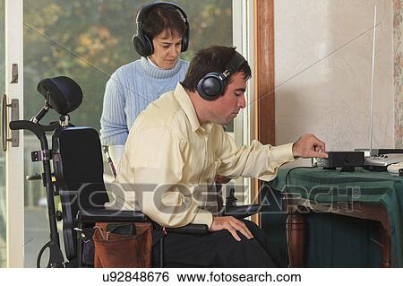 Stock Photograph - Disabled couple using headphones. Fotosearch