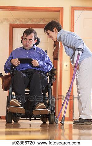 Stock Image - Disabled couple using tablet. Fotosearch