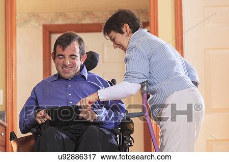 Stock Photo - Disabled couple using tablet. Fotosearch