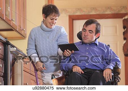 Stock Photography - Disabled couple using tablet. Fotosearch