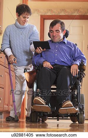 Stock Photography - Disabled couple using tablet. Fotosearch