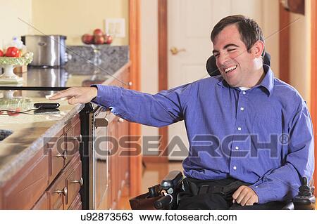 Disabled man in his kitchen View Large Photo Image Stock Image - Disabled man in his kitchen. Fotosearch