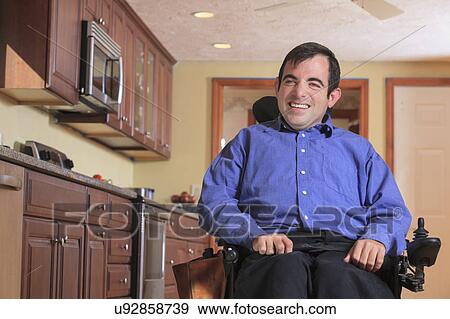 Stock Photo - Disabled man in his kitchen. Fotosearch