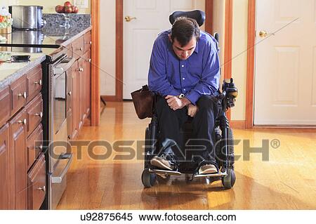 Stock Photography - Disabled man in his kitchen. Fotosearch